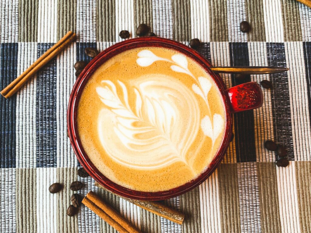 flat lay photography of coffee latte with art