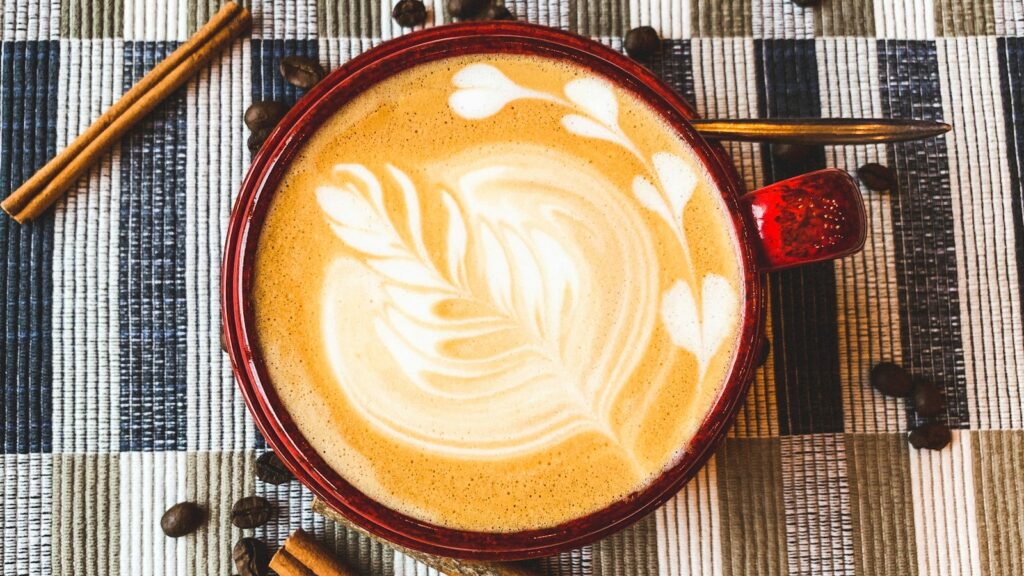 flat lay photography of coffee latte with art
