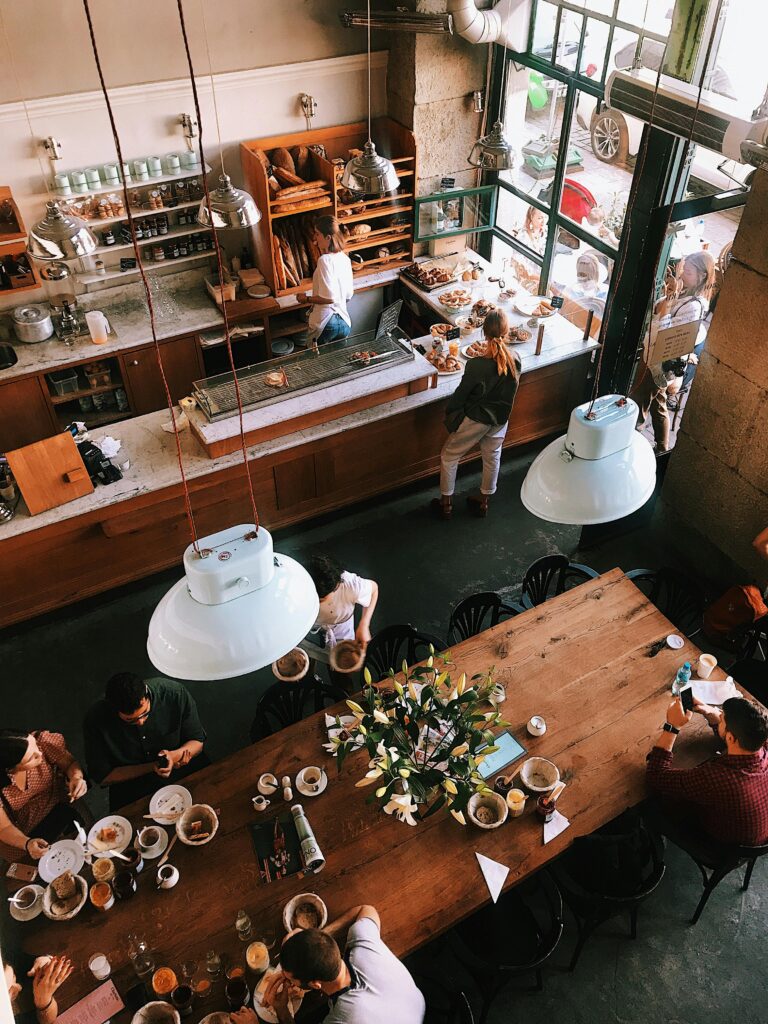 Best Cairns Cafes, A vibrant aerial view of a busy cafe in Kraków, showcasing patrons enjoying baked goods and coffee.