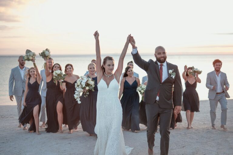 Whitsundays wedding venues, a group of people standing on top of a beach