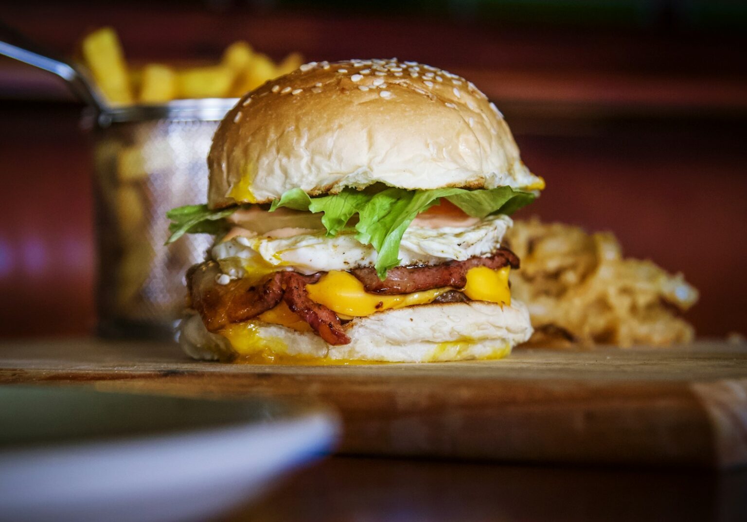 Best Restaurants in Cairns, a bacon, egg, and cheese sandwich with a side of potato chips