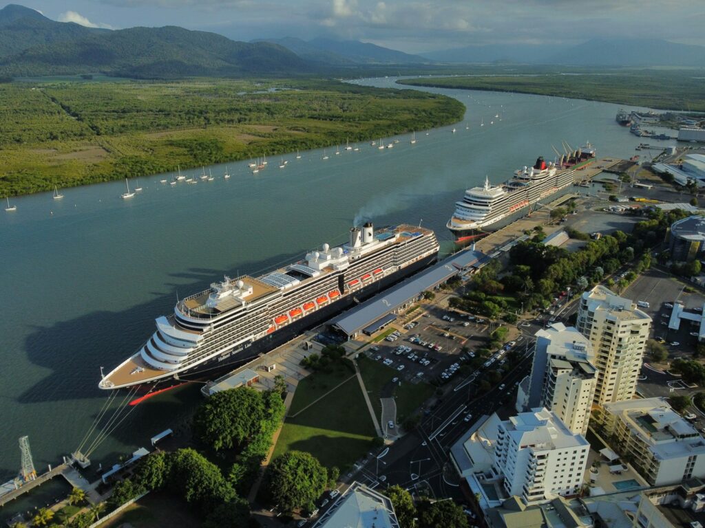 Things to do in Cairns, a cruise ship docked in a harbor next to a city