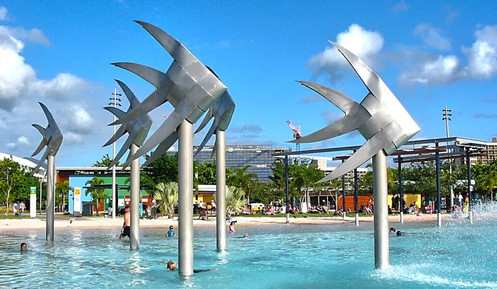 Things to do in Cairns, Cairns Esplanade Hotels, people walking on park with gray concrete fountain during daytime