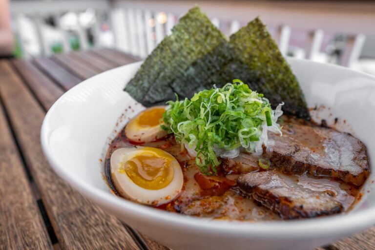 A mouthwatering bowl of ramen with chashu pork, eggs, and green onions, perfect for dining delight.