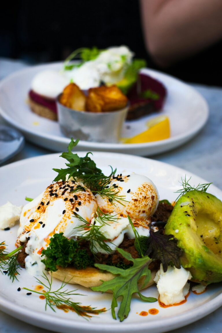 Best restaurants in Cairns, Delicious poached eggs served with avocado and fresh greens, perfect for a healthy gourmet brunch.