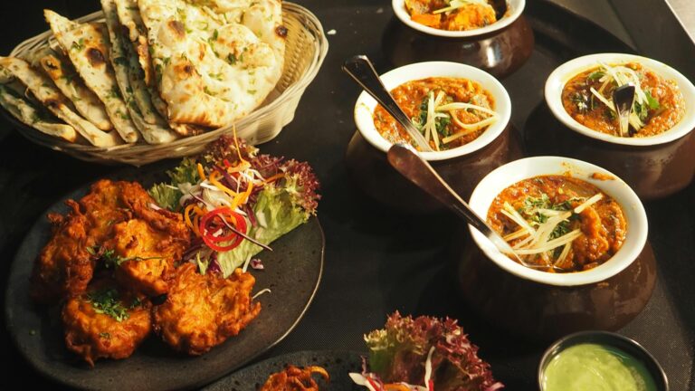 Best restaurants in Cairns, A mouth-watering display of Indian cuisine featuring naan, curry, and pakoras perfect for a delightful meal.